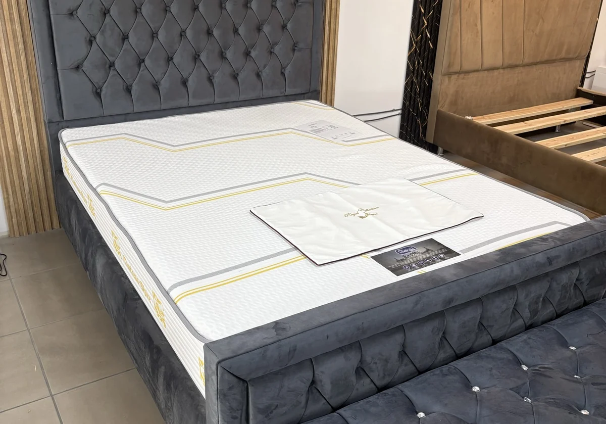 Rome mattress on a grey buttoned bed at Zavvinko Ipswich